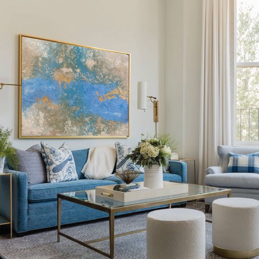 Living room with blue sofa, gray armchair, and abstract painting on wall